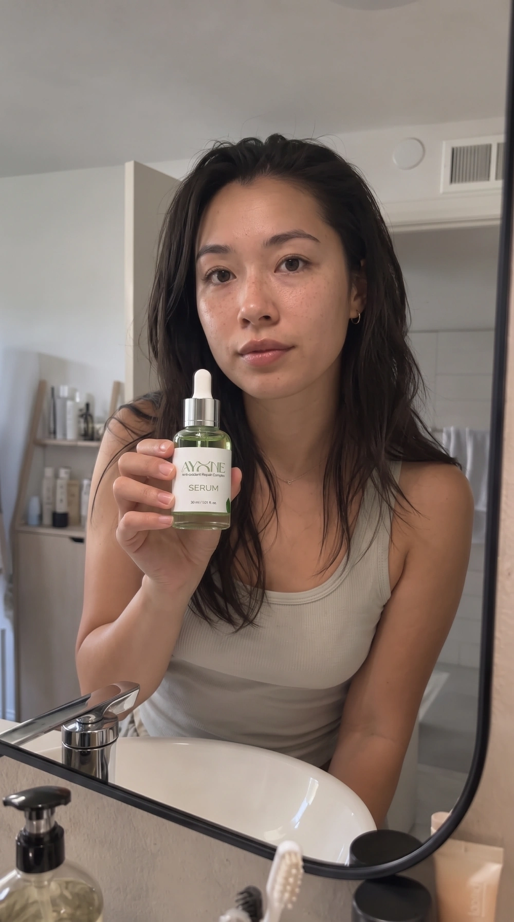 Model holding the Ayone Serum bottle, reference image for the reveal clip