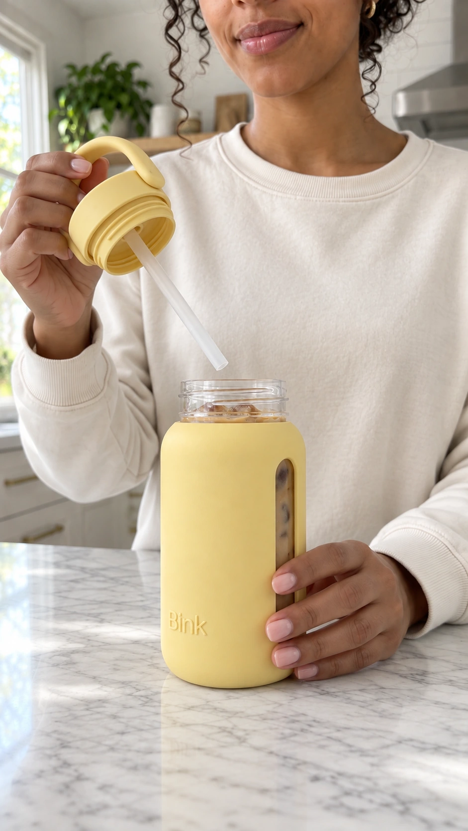 Reference image of the model holding the Bink bottle cap